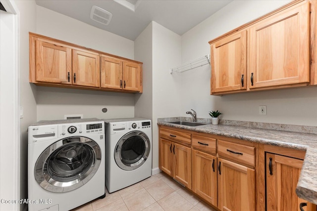 clothes washing area featuring cabinet space, light tile patterned floors, visible vents, separate washer and dryer, and a sink