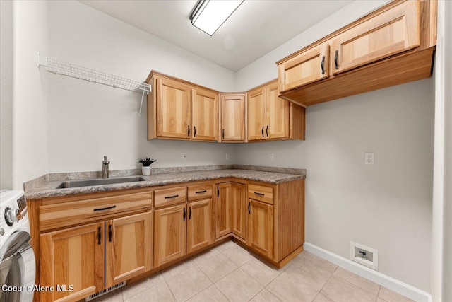 washroom with light tile patterned floors, a sink, visible vents, cabinet space, and washer / dryer