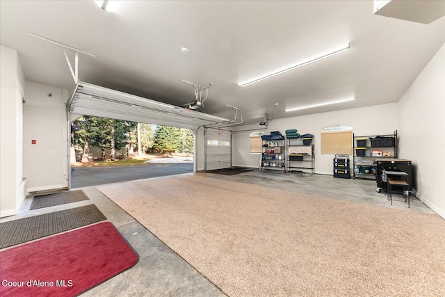 garage with a garage door opener and baseboards