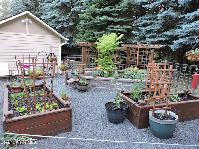 view of patio / terrace with a vegetable garden and fence