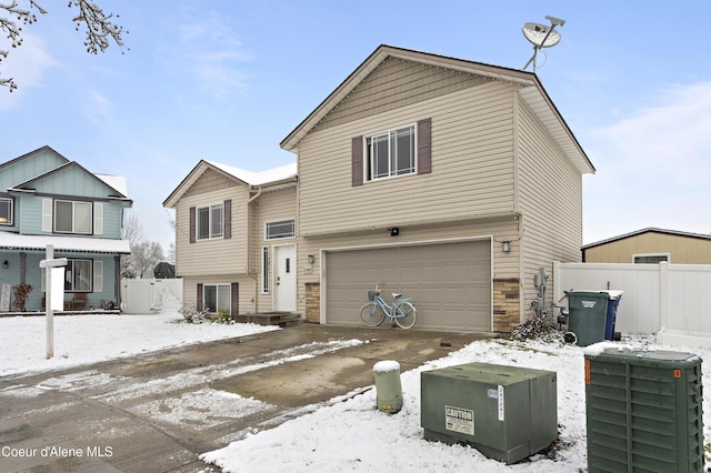 view of front of house with cooling unit and a garage