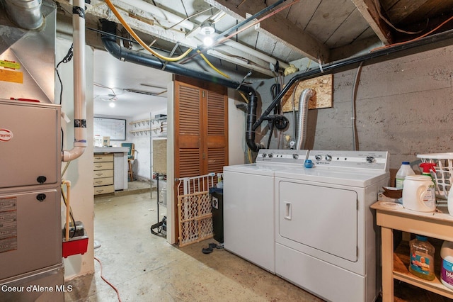 laundry room with separate washer and dryer and heating unit