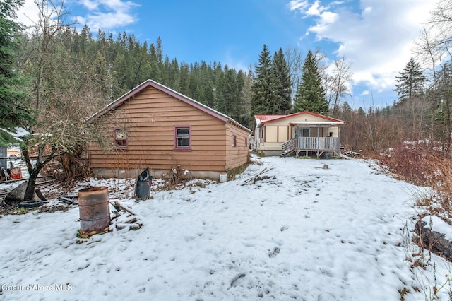 view of snow covered rear of property