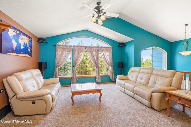 carpeted living room with ceiling fan and lofted ceiling