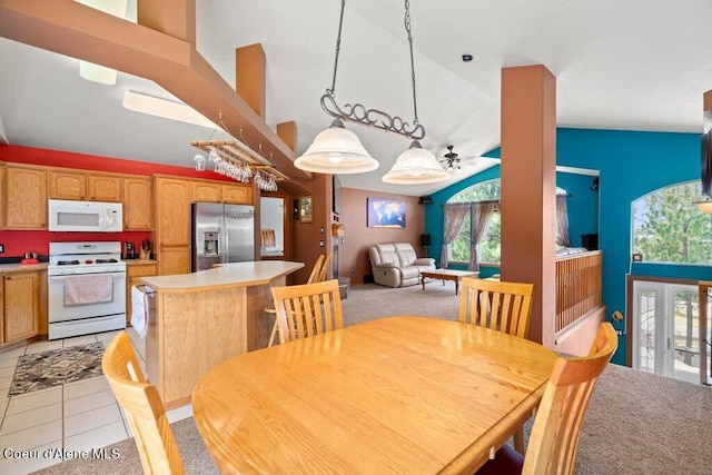 tiled dining area featuring ceiling fan and high vaulted ceiling