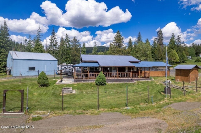 view of front of home with a front yard and an outdoor structure