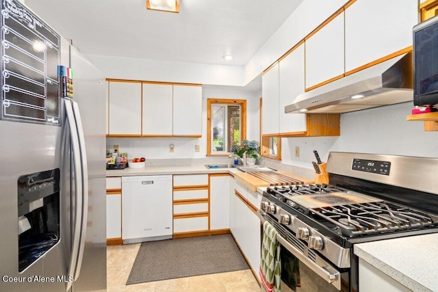 kitchen with stainless steel appliances and white cabinets