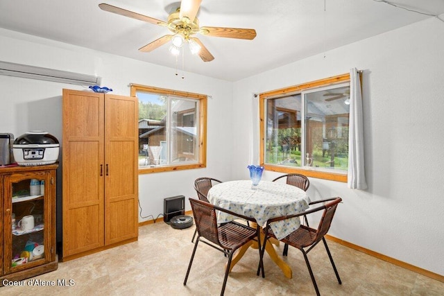 dining room with ceiling fan and light colored carpet