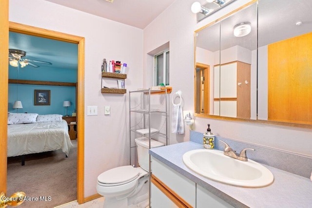 bathroom featuring toilet, ceiling fan, and vanity