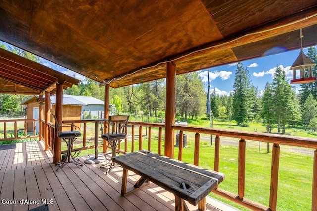 wooden deck featuring a yard