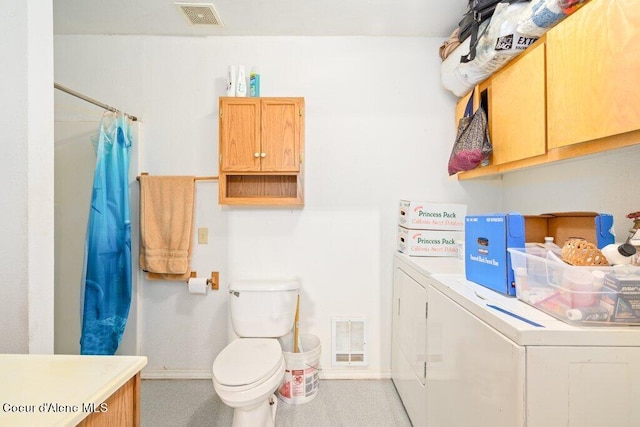 bathroom featuring washer and dryer, walk in shower, vanity, and toilet