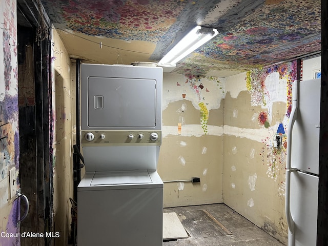 laundry room featuring stacked washer and clothes dryer