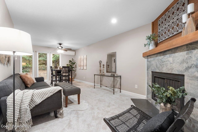 carpeted living room featuring ceiling fan, an AC wall unit, and a fireplace