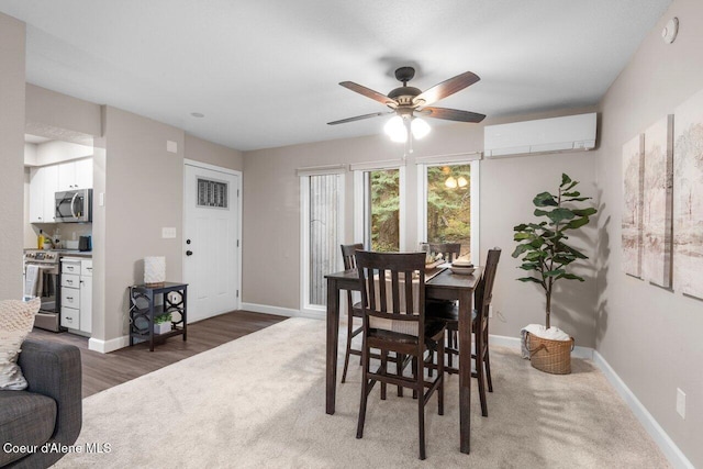 dining space featuring a wall unit AC, ceiling fan, and dark wood-type flooring