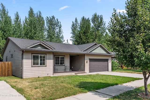 single story home with a garage and a front lawn