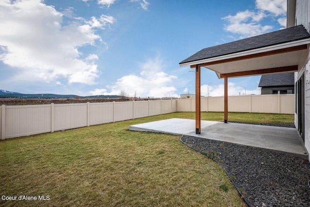 view of yard featuring a patio area and a mountain view