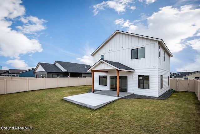 back of property featuring a patio area and a yard