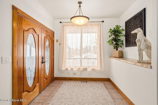 foyer entrance with light tile patterned floors