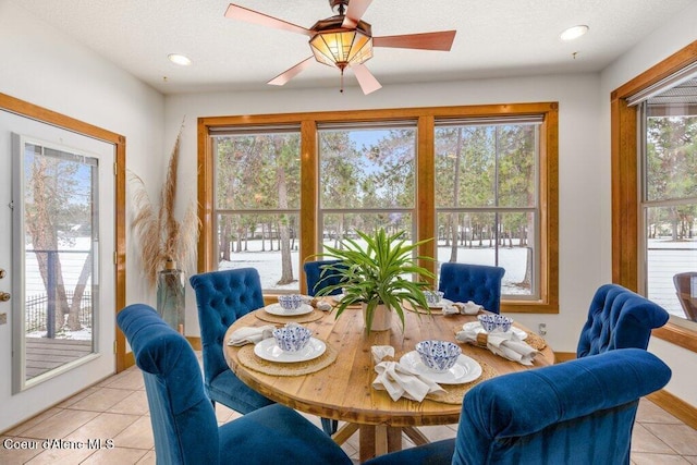 tiled dining area with ceiling fan