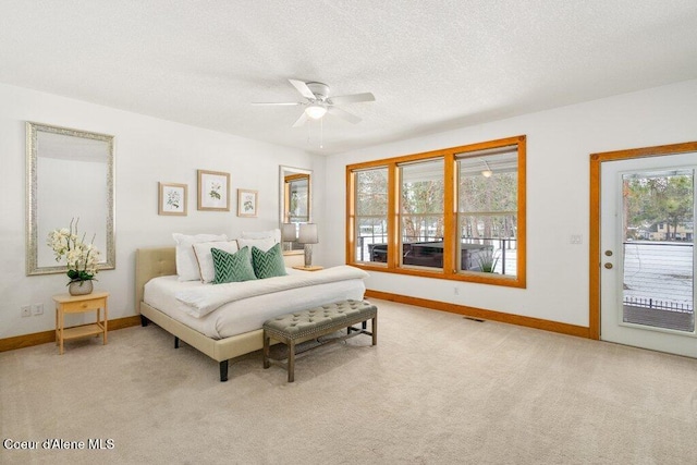 carpeted bedroom with access to exterior, ceiling fan, and a textured ceiling