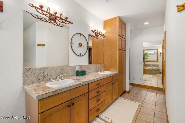 bathroom featuring vanity, tile patterned flooring, and decorative backsplash