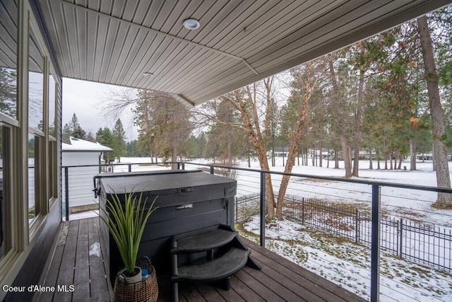 snow covered deck featuring a hot tub