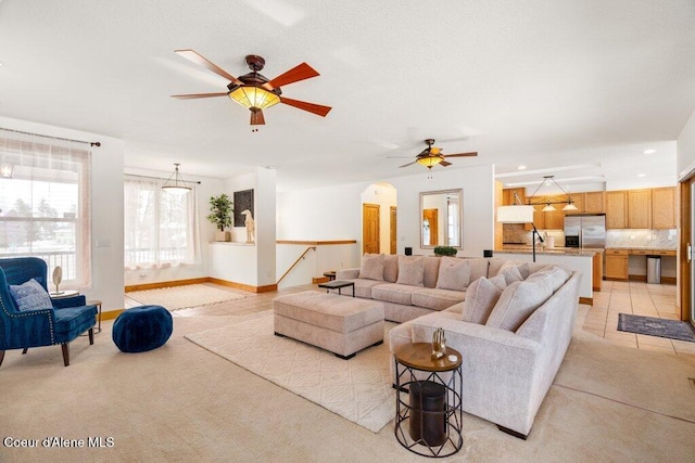 tiled living room featuring sink and ceiling fan