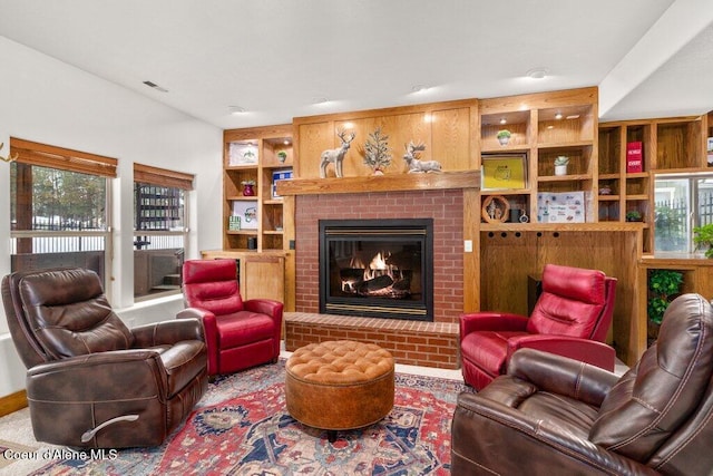 living room featuring a fireplace and built in features