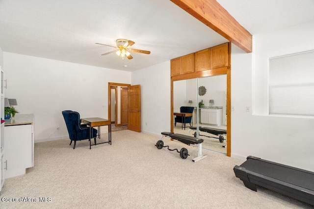 exercise area with ceiling fan and light carpet