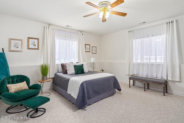 bedroom featuring light carpet and ceiling fan