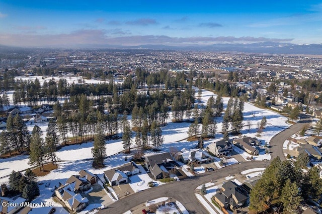 snowy aerial view with a mountain view