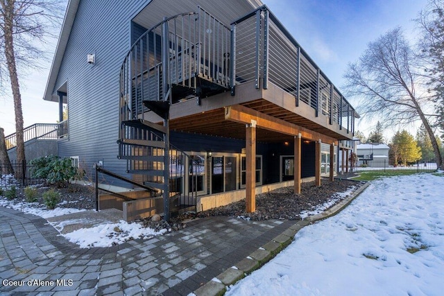 view of snow covered rear of property