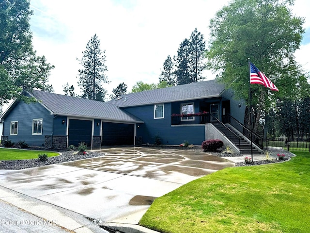 706 N Dundee Dr, Post Falls, ID 83854 - view of front of home featuring a garage, driveway, stairway, metal roof, and stone siding