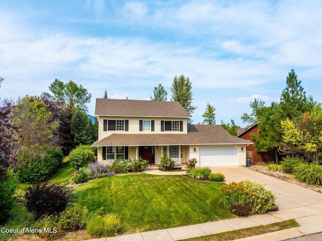 view of front of house with a front lawn and a garage