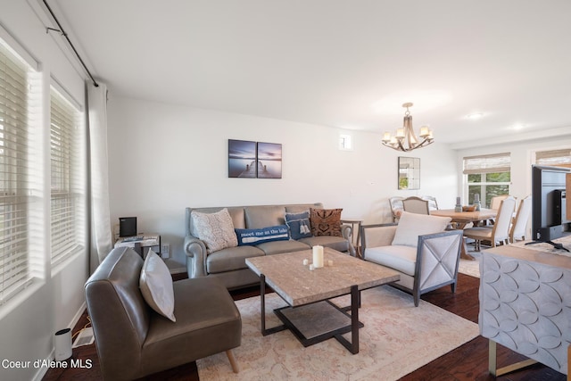 living room featuring hardwood / wood-style floors and a notable chandelier