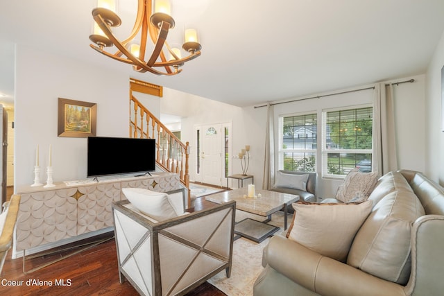 living room with dark hardwood / wood-style flooring and a chandelier