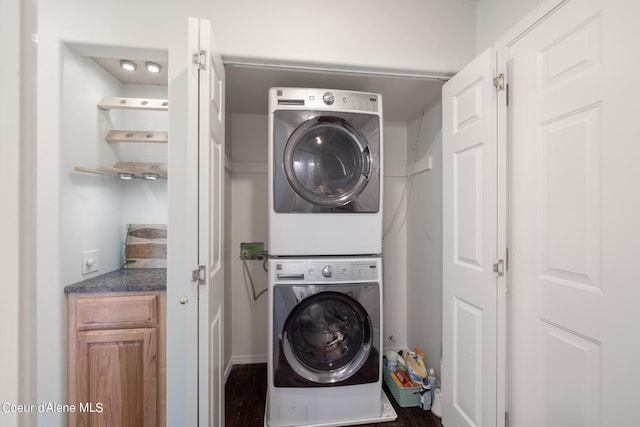 washroom featuring stacked washer / drying machine