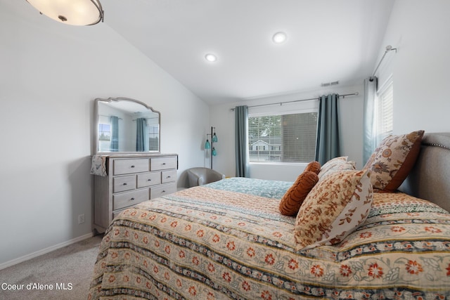 carpeted bedroom with vaulted ceiling and multiple windows