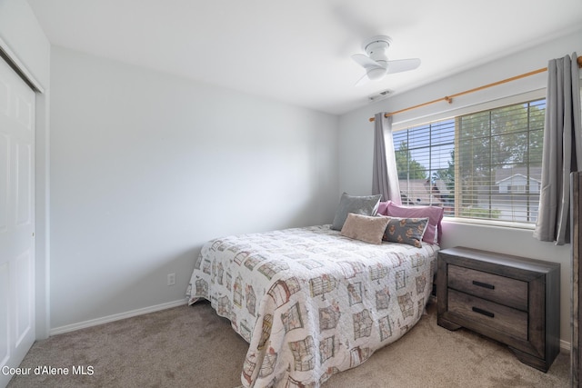 bedroom with ceiling fan, a closet, and light colored carpet