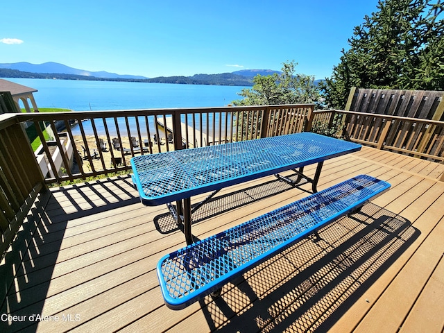 deck with a water and mountain view