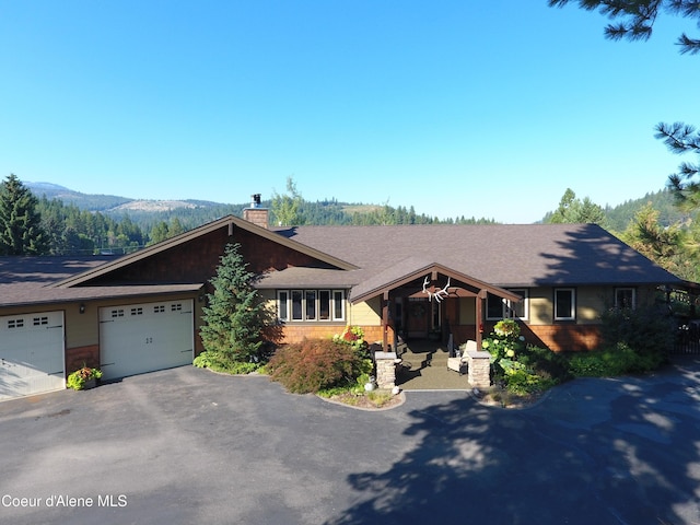 single story home featuring a mountain view and a garage