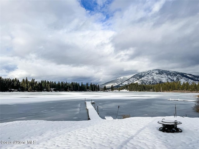 snowy yard with a mountain view