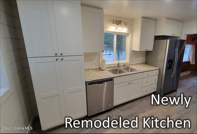 kitchen featuring white cabinets, appliances with stainless steel finishes, and sink