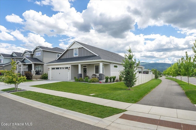 craftsman house with a mountain view, a porch, and a front yard