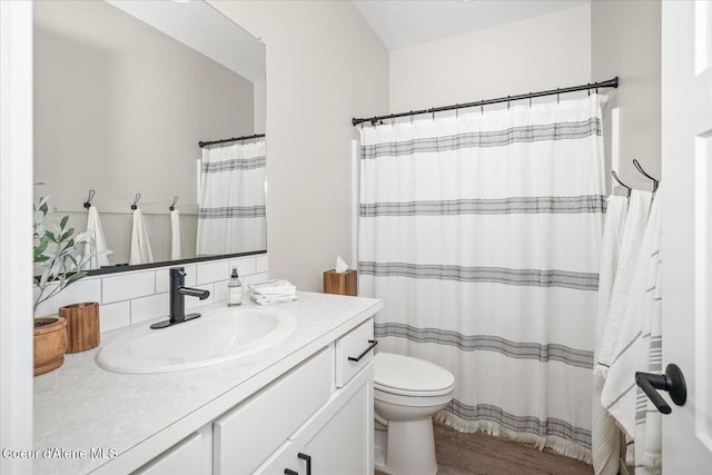 bathroom with hardwood / wood-style flooring, vanity, and toilet