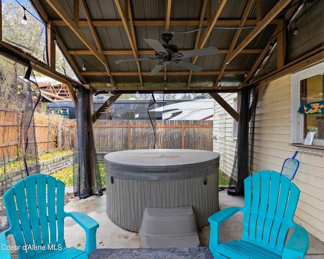 view of patio featuring a gazebo, a hot tub, and ceiling fan