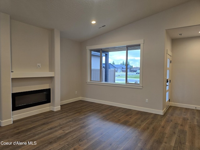 unfurnished living room with built in shelves, dark hardwood / wood-style flooring, and vaulted ceiling