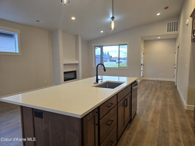 kitchen with stainless steel dishwasher, sink, hardwood / wood-style flooring, a center island with sink, and lofted ceiling