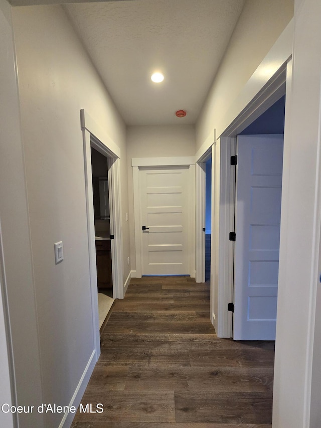 corridor featuring dark hardwood / wood-style floors