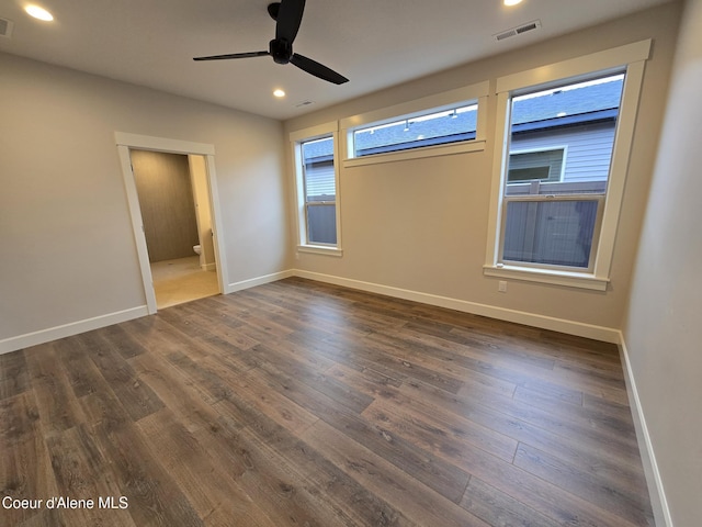 unfurnished room with ceiling fan and dark wood-type flooring